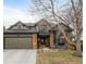 Charming two-story home featuring a brick and siding exterior, manicured landscaping, and an attached two-car garage at 19080 E Low Cir, Aurora, CO 80015