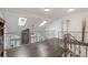 Upstairs hallway featuring wood floors, skylights, and an ornamental railing at 19080 E Low Cir, Aurora, CO 80015