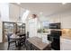 Kitchen with granite countertops, stainless steel appliances, tile backsplash, and eat-in table with natural light at 19080 E Low Cir, Aurora, CO 80015