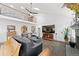 Open-concept living room with hardwood floors, high ceilings, a fireplace, and a comfortable seating arrangement at 19080 E Low Cir, Aurora, CO 80015