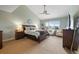 Spacious main bedroom featuring a ceiling fan, sitting area, and large windows at 19080 E Low Cir, Aurora, CO 80015