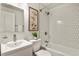 Bright bathroom features modern vanity, white tiling in shower and artwork on wall at 4729 N Meade St, Denver, CO 80211