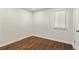 Empty bedroom with hardwood floors, one window, neutral walls and white trim at 4729 N Meade St, Denver, CO 80211