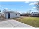 View of detached garage with blue door and concrete pad at 4729 N Meade St, Denver, CO 80211