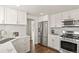 Bright kitchen with stainless steel appliances, modern finishes, and ample storage at 4729 N Meade St, Denver, CO 80211