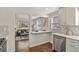 Bright kitchen with breakfast bar, stainless steel dishwasher, and views into the living room at 4729 N Meade St, Denver, CO 80211