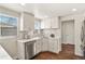 Modern kitchen with white cabinets, marble countertops, and stainless steel appliances at 4729 N Meade St, Denver, CO 80211