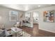 Stylish living room with wood floors, breakfast bar, and view into the kitchen at 4729 N Meade St, Denver, CO 80211