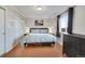 This is a bedroom with wood floors, large window, chest of drawers, gray walls and white trim at 1927 Kenton St, Aurora, CO 80010