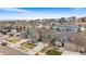 Scenic aerial view of a residential area with houses, landscaping, and views of the surrounding neighborhood and nearby lakes at 17748 W 95Th Ave, Arvada, CO 80007