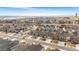 Aerial view of a neighborhood showcasing well-maintained homes, green spaces, and scenic surroundings at 17748 W 95Th Ave, Arvada, CO 80007