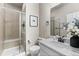 Neutral bathroom with a step-in shower boasting a tile surround and seamless glass enclosure at 17748 W 95Th Ave, Arvada, CO 80007