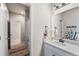 Bright and airy bathroom featuring a sleek vanity and well-placed mirrors with a view of the shower and tub at 17748 W 95Th Ave, Arvada, CO 80007