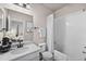 Bright bathroom with a tub/shower combination and a view of a bedroom at 17748 W 95Th Ave, Arvada, CO 80007