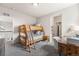 Cozy bedroom featuring a wooden bunk bed, a desk, and neutral-toned walls, perfect for a room at 17748 W 95Th Ave, Arvada, CO 80007