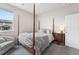 Cozy bedroom with a four poster bed, plush carpet, and a window providing ample natural light at 17748 W 95Th Ave, Arvada, CO 80007