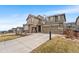 Charming two-story home with a three-car garage and a basketball hoop on a sunny day at 17748 W 95Th Ave, Arvada, CO 80007