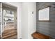 Hallway with hardwood flooring leading to a kitchen view; wainscoting and a bench adorn the walls at 17748 W 95Th Ave, Arvada, CO 80007