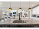 Elegant kitchen with a large island, granite countertops, and stainless steel appliances at 17748 W 95Th Ave, Arvada, CO 80007