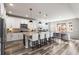 Well-lit kitchen with stainless steel appliances, a breakfast bar, and hardwood flooring at 17748 W 95Th Ave, Arvada, CO 80007