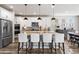Stylish kitchen island with pendant lighting, granite countertops, and seating for four at 17748 W 95Th Ave, Arvada, CO 80007