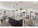 Beautiful kitchen with granite countertops, stainless steel appliances, and views into the living room at 17748 W 95Th Ave, Arvada, CO 80007