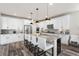 Modern kitchen featuring white cabinetry, stainless steel appliances, and a spacious island at 17748 W 95Th Ave, Arvada, CO 80007