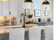 Kitchen island with granite countertop, modern fixtures, and ample lighting; perfect for food preparation and entertaining at 17748 W 95Th Ave, Arvada, CO 80007