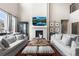 Inviting living room featuring a cozy fireplace, contemporary decor, and comfortable seating at 17748 W 95Th Ave, Arvada, CO 80007