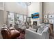 Cozy living room with a fireplace, large windows, comfortable seating, and contemporary decor at 17748 W 95Th Ave, Arvada, CO 80007