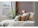Plush bedding with a variety of decorative pillows highlight this comfortable main bedroom at 17748 W 95Th Ave, Arvada, CO 80007