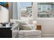Comfortable sitting area with cushioned chair positioned by a window and stylish decor at 17748 W 95Th Ave, Arvada, CO 80007