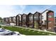 Modern townhomes with mixed brick and siding exterior, individual balconies, and attractive landscaping at 4 Ascent Trl, Englewood, CO 80112
