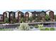 Modern townhomes with mixed brick and siding exterior, charming landscaping, and individual balconies at 4 Ascent Trl, Englewood, CO 80112