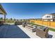 Backyard oasis with a fire pit, built in BBQ, and a relaxing seating area at 6255 Kenzie Cir, Castle Pines, CO 80108