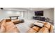Expansive finished basement features large television, comfortable seating, and plenty of room to relax at 6255 Kenzie Cir, Castle Pines, CO 80108