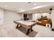 Finished basement with entertainment area features a large air hockey table and comfortable seating at 6255 Kenzie Cir, Castle Pines, CO 80108