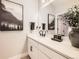 Modern bathroom featuring a neutral color palette, single vanity, and stylish decorative elements at 6255 Kenzie Cir, Castle Pines, CO 80108