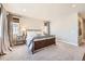 Light-filled bedroom with neutral decor, stylish furnishings, and large windows at 6255 Kenzie Cir, Castle Pines, CO 80108