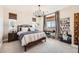 Bedroom featuring a full-sized bed, desk, and large windows at 6255 Kenzie Cir, Castle Pines, CO 80108