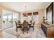Comfortable dining room with large windows, natural light, and sliding door to the outside at 6255 Kenzie Cir, Castle Pines, CO 80108
