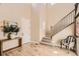 Elegant foyer featuring hardwood floors, staircase, and stylish console table at 6255 Kenzie Cir, Castle Pines, CO 80108