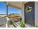 Cozy front porch with bench seating, decorative wreath, and scenic neighborhood views at 6255 Kenzie Cir, Castle Pines, CO 80108
