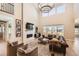 Bright living room with a modern fireplace, comfortable seating, and large windows at 6255 Kenzie Cir, Castle Pines, CO 80108