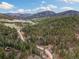 Elevated view of the property nestled among vast woodlands, highlighting its peaceful and private setting at 7559 S Turkey Creek Rd, Morrison, CO 80465