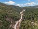 Expansive aerial view of the property nestled in the forest, emphasizing the natural beauty and seclusion at 7559 S Turkey Creek Rd, Morrison, CO 80465