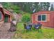 Lawn with outdoor table & chairs, a stone accent on house, mature trees, and a barbecue at 7559 S Turkey Creek Rd, Morrison, CO 80465
