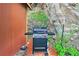 Outdoor barbecue features a gas grill near a wooden shed and rock formation at 7559 S Turkey Creek Rd, Morrison, CO 80465