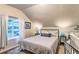 Cozy bedroom features natural light from the window and stylish lamps on the nightstands at 7559 S Turkey Creek Rd, Morrison, CO 80465