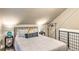 Comfortable bedroom has sloped ceiling, unique decor and a clothes rack for storage at 7559 S Turkey Creek Rd, Morrison, CO 80465